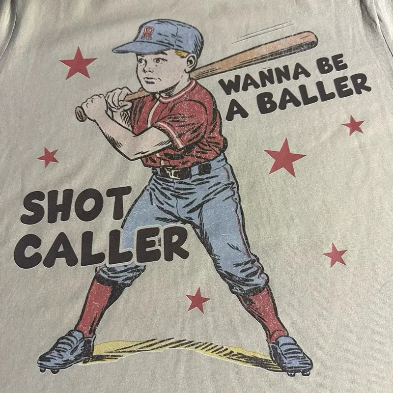 Baller Shot Caller Baseball Shirt - Red Cap, Blue Outfit, Graphic Design Featuring Baseball Bat and "Wanna Be A Baller" Text