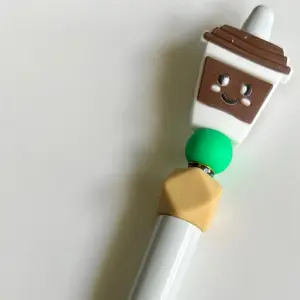 White pen with brown Cofee Cup