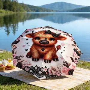 Portable folding umbrella The umbrella features a cute cow character with a black bow, surrounded by pink roses, hearts, and lace. Suitable for daily travel use, holiday Gift