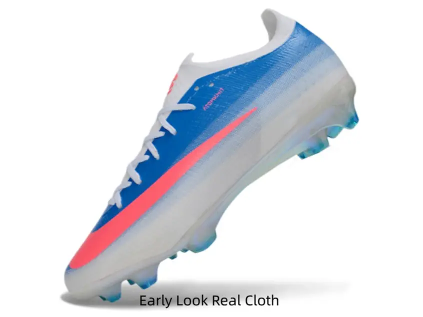 Fresh blue-white gradient soccer cleats with hot pink accents, eye-catching on natural grass