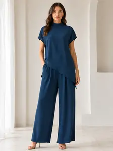 Elegant two-piece set for women: an asymmetrical mock neck top with cover sleeves paired with wide-leg casual pants. Loose, relaxed style—perfect for summer vacations and home wear; versatile coordinated outfit.
