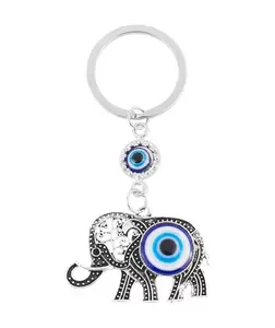 Silver Elephant Keychain with Blue Evil Eye Charm - Intricate Design on Wooden Surface for E-commerce Display
