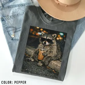 Funny Raccoon Drinking Iced Coffee Shirt: Animal Meme Graphic Tee