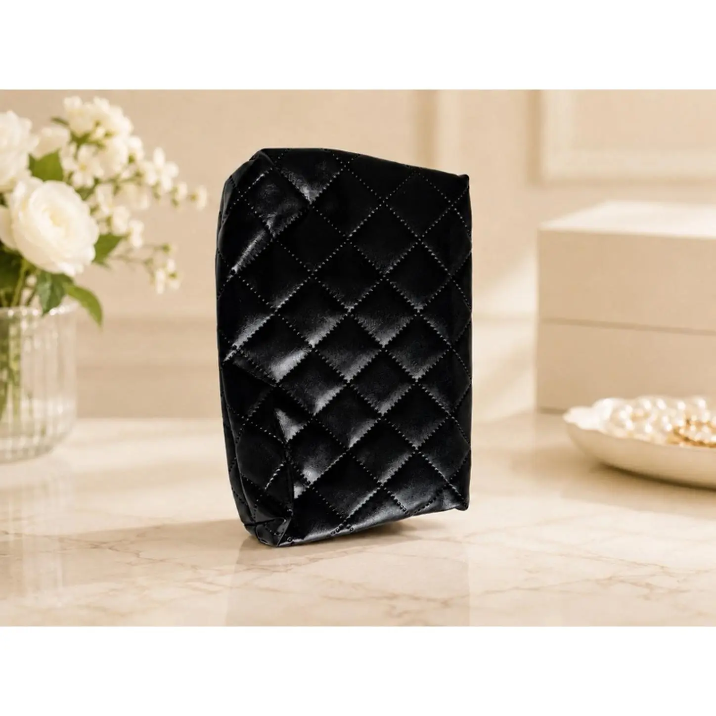 Elegant Black Quilted Cosmetic Bag with Secure Closure, Ideal for Travel and Daily Use