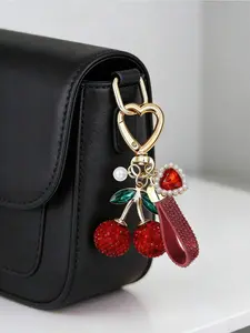 Sparkling cherry keychain embellished with rhinestones and red gems. Exquisite gold charm for bags, backpacks and car keys. Perfect gift for birthdays, Mother’s Day, Valentine’s Day, weddings and Christmas.