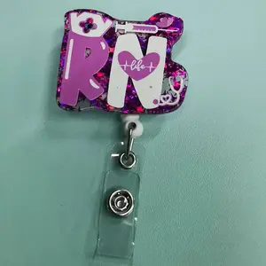A registered nurse (RN) themed work card retractable buckle Badge Reels, the main body is designed with purple glitter, with "RN" text, with nurse hat, syringe, heart shape (including "life" and heartbeat line pattern) and other medical elements;