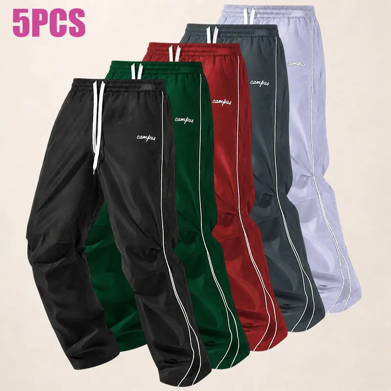 5-pack men’s loose athletic wide-leg pants with side white stripes, drawstring elastic waistband, lightweight wrinkle-resistant fabric, campus letter embroidery, straight cut street style, windproof sports long pants—men’s casual pants.