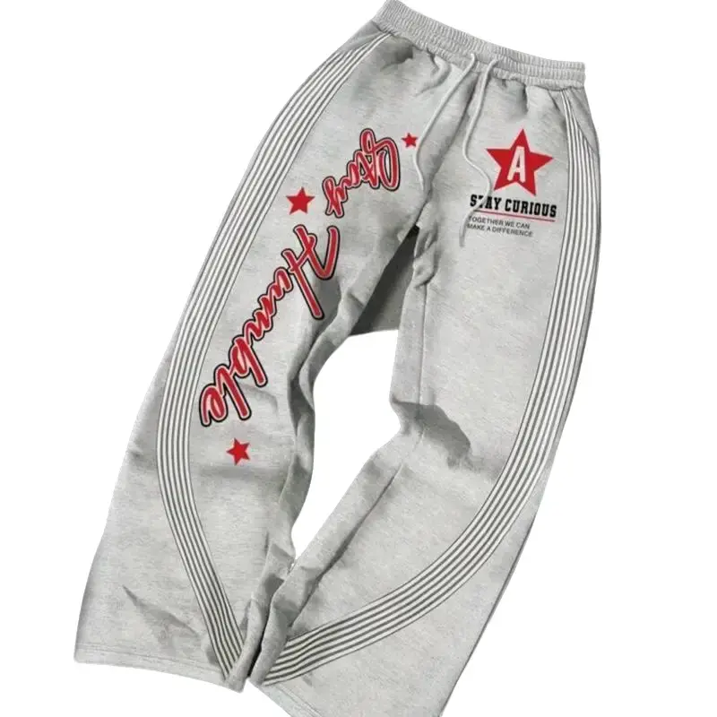 Manfinity EMRG Casual Sports Pants for Men with Graphic Print of Letters and étoiles, Drawstring Waist, Loose and Flared Design