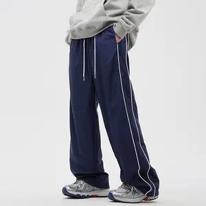 A pair of men's navy blue wide leg casual pants with white stripes down the side, featuring a trendy street style. The bold white stripe design adds a stylish and dynamic touch to the overall look, showcasing individuality and fashionable taste.