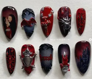 Gothic vampire-inspired nail art with dark red tones, Dracula imagery, spider webs, bats, and 3D metal accents