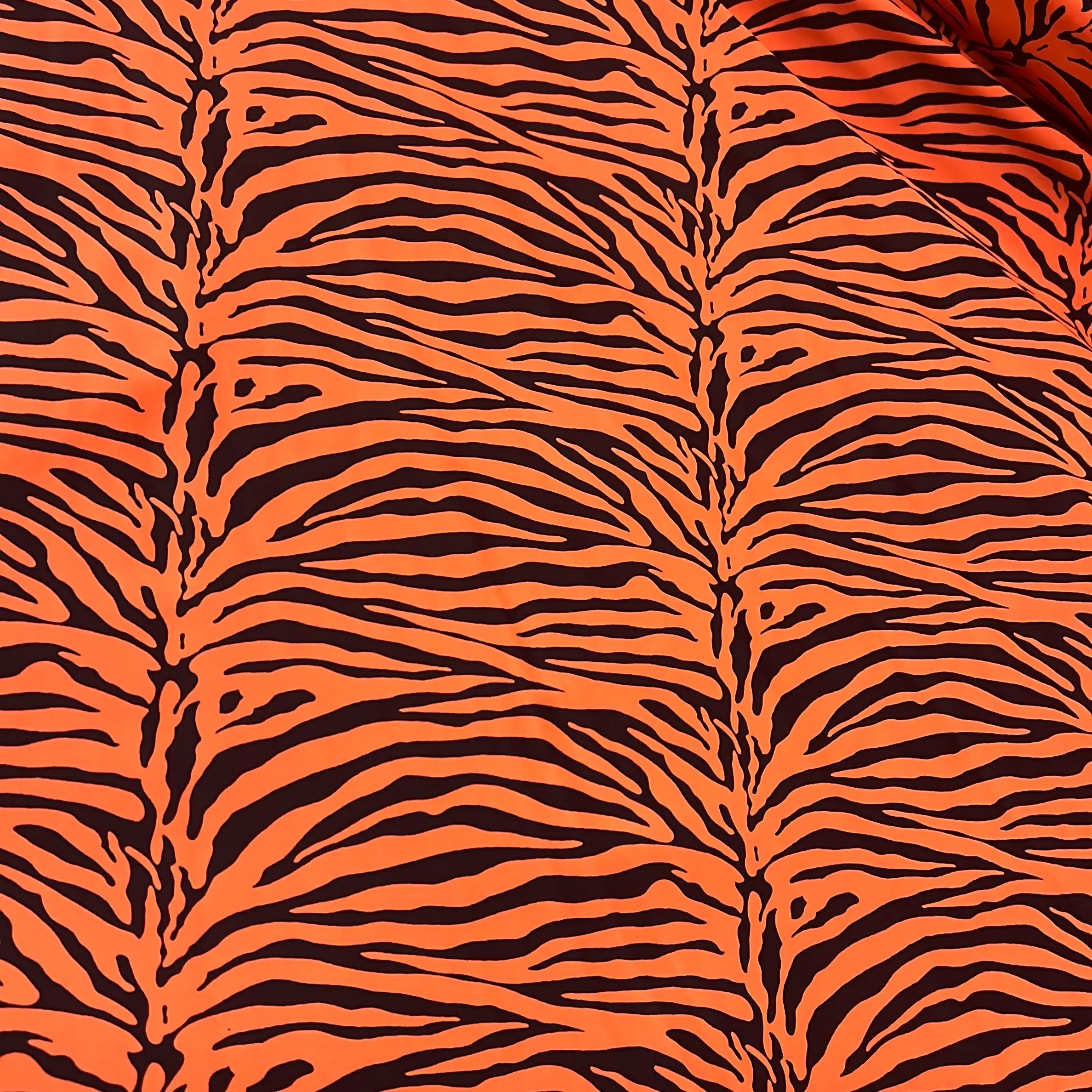 Neon orange tiger print on 4 way stretch on nylon spandex fabric sold by the yard