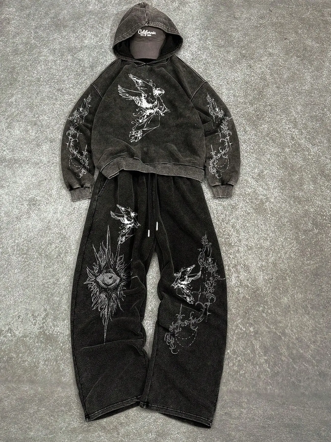 Men's Acid Wash Oversized Hoodie Set with Fallen Angel Print, Dark Opium Aesthetic Casual Two-Piece Tracksuit Outfit, Gothic Evil Eye Graphic Heavyweight Fleece Sweatshirt and Baggy Joggers for Streetwear Enthusiasts.