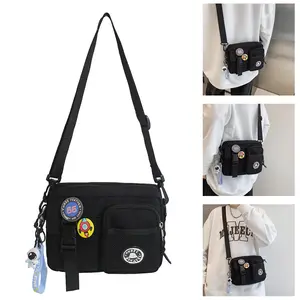Unisex Casual Plain Color Release Buckle Crossbody Bag with Astronaut Charm Lightweight Nylon & Canvas Messenger Bag for Women with Random Color Badge