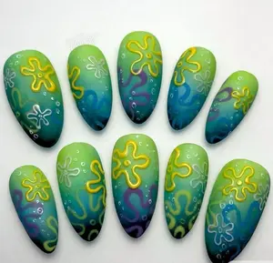 SpongeBob-inspired underwater nails — featuring a gradient of sea green to ocean blue with 3D yellow and purple coral-like squiggles, echoing the iconic Bikini Bottom background in a playful matte finish