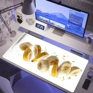 Modern Clean Desk Setup with White Surface - Includes Banana Plate, Computer Monitor, Alarm Clock, Desk Lamp, Fan, Mugs, Speaker, Headphones, Purple Cup, Weather Widget - Cool Blue