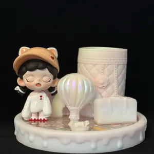 Handmade resin pen/makeup brush holders with liquid glitter base decorated with blindbox figurine.