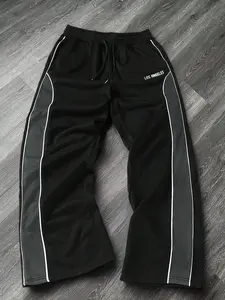 A pair of black American retro "LOS ANGELES" letter print side color-blocking sports pants with drawstring elastic waist design, suitable for street fashion enthusiasts, casual outings and daily trendy outfits