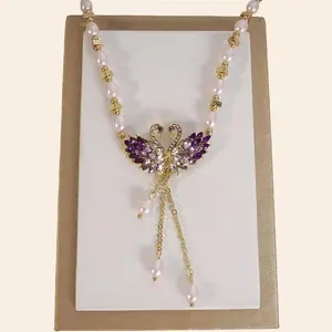 Rotating Pearl Necklace with Purple Swan Butterfly Lotus Camellia Pendants for Sweaters & Outfits Adjustable Chain Length Hypoallergenic Material