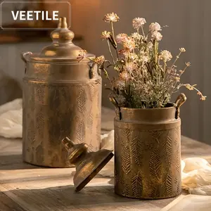 A vintage-style metal dried flower vase, a tabletop decoration with an embossed design. This decorative cylindrical vase is suitable for home décor, tabletop decoration, and wedding photography entrance props. Perfect for personal use or as a gift.