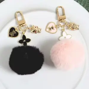 Two Adorable Keychain with Black and Pink Pom Poms and Heart Charms for Stylish Accessories