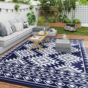 Reversible rhombus patterned polypropylene outdoor rug with waterproof and sun resistant performance easy to clean and maintain equipped with four corner loop straps wind stable design perfect for laying in gardens balconies and terraces