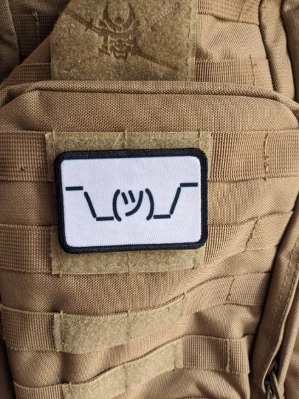 Text idk guy shrugging shoulders white background meme 2"x3" morale patch with hook and loop backing