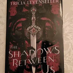 The Shadows Between Us by Tricia Levenseller (Special Edition Hardcover with Stenciled Edges)
