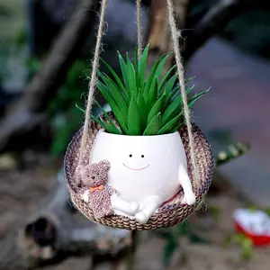 Hang flower pots together with smiling faces and bear indoor plants. The unique and interesting flower pots are lovely decorations for the garden flower pots, making them perfect for a home office.