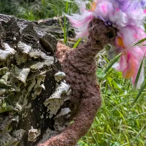 Cute Crochet Troll: Image of a Pink and Purple Crocheted Troll  Next to a Tree Trunk