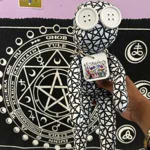 Power. Protection. Spirit in perfect balance.  This Pentacle Hoodoo Doll is a vessel of divine order and sacred defense — a guardian spirit crafted to protect, bless, and empower the one who tends it. Wrapped in fabric covered with pentacles, this doll ra
