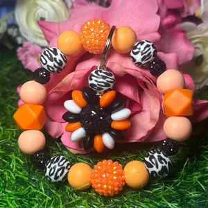 Eye of the tiger wristlet keychain color scheme black, peach, orange and bling beads made with wire