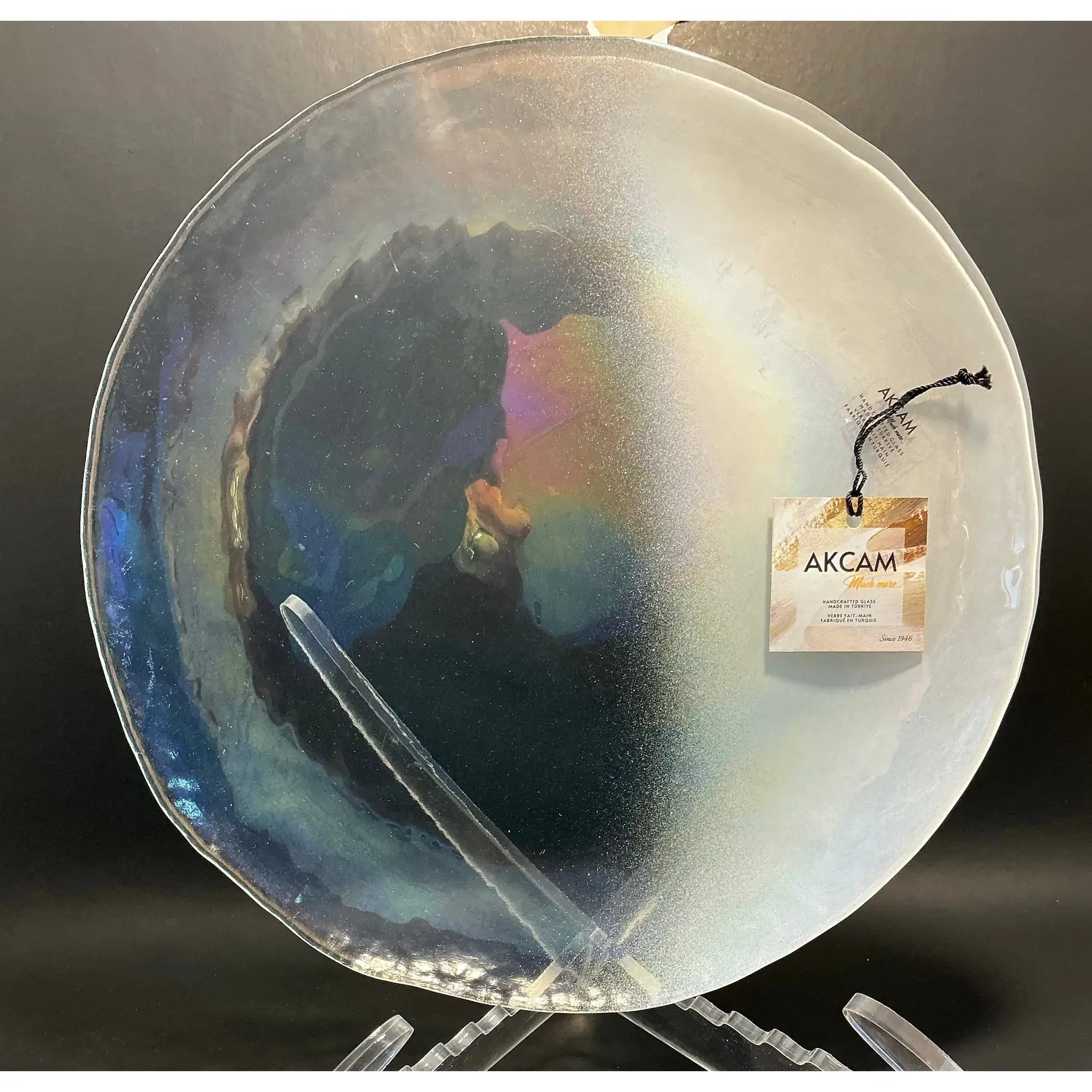 Akcam Iridescent Dinner plate 12”which is handmade in Turkey with their shimmering opal-like finish that changes color with light.