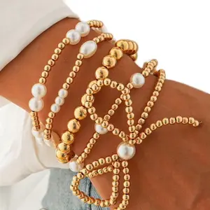 Gold Pearl Bow Bracelet Stack with Decorative Elements and Pearl Accents