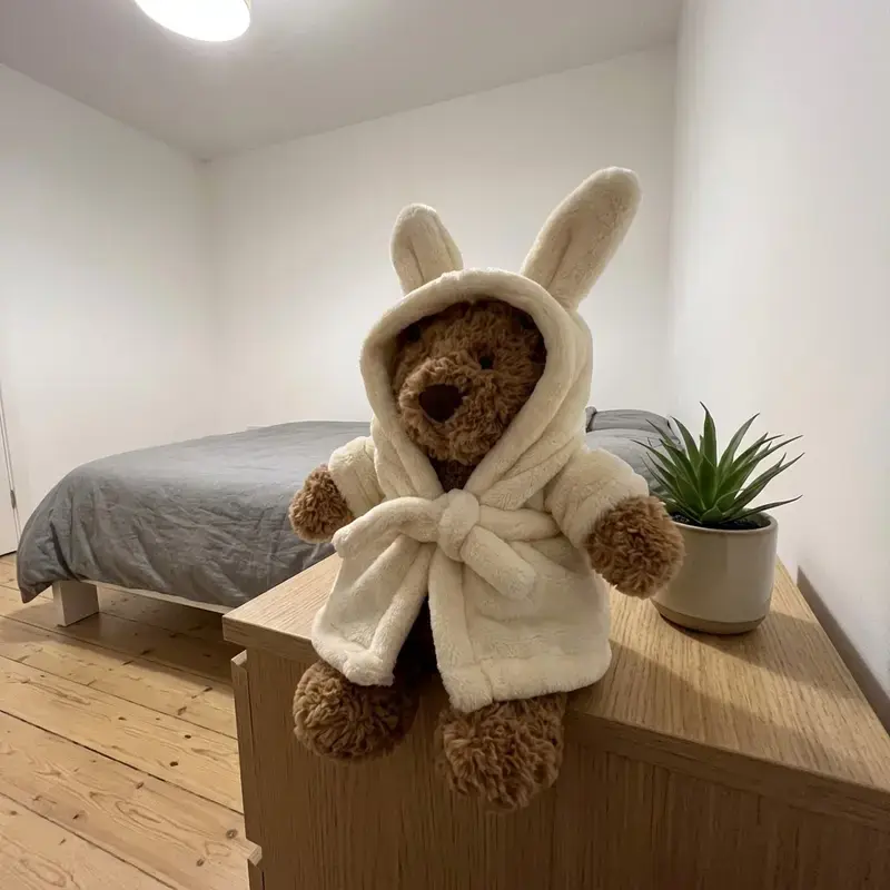 Jellycat Bartholomew Bear in a bathrobe (a version of Bartholomew Bear wearing a creamy-brown plush bathrobe featuring attached bunny ears). A truly delightful gift.