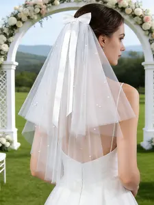 Sweet & elegant short bridal veil featuring a ribbon bow—the perfect veil for a garden wedding