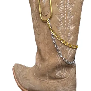 The Original Boot Jewelry Two-Tone Double Chain Boot Charm Features dual-layer chains in mixed metal tones with secure carabiner screw clips that easily attach to boot pull tabs. Removable, interchangeable.