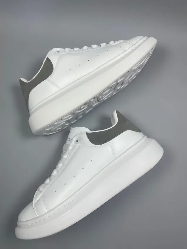Clean white platform sneakers with grey heel patch, thick sole adds height and matches all casual outfits.