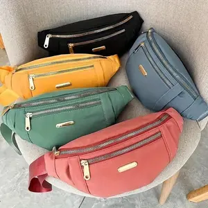 Lightweight Nylon Waist Pack with Adjustable Shoulder Strap and Zip Closure Large Capacity Hands-Free Unisex Gym Bag and Backpack Alternative Durable Spacious Design Ideal for Fitness and Training Secure Zip Closure Gold Hardware Multiple Colors