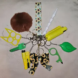 Beautiful Keychain Set with Unique Accessories Including a Pom Pom, Yellow Tool, and More