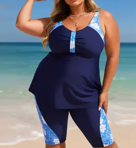 Plus Size Navy Floral Colorblock Separated Swimsuit Flowy navy tankini top with tropical floral print accents, paired with matching knee-length swim capris. Sporty, full-coverage design for water activities Summer Vibes