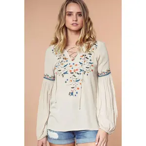 Long sleeve lace-up embroidered blouse.