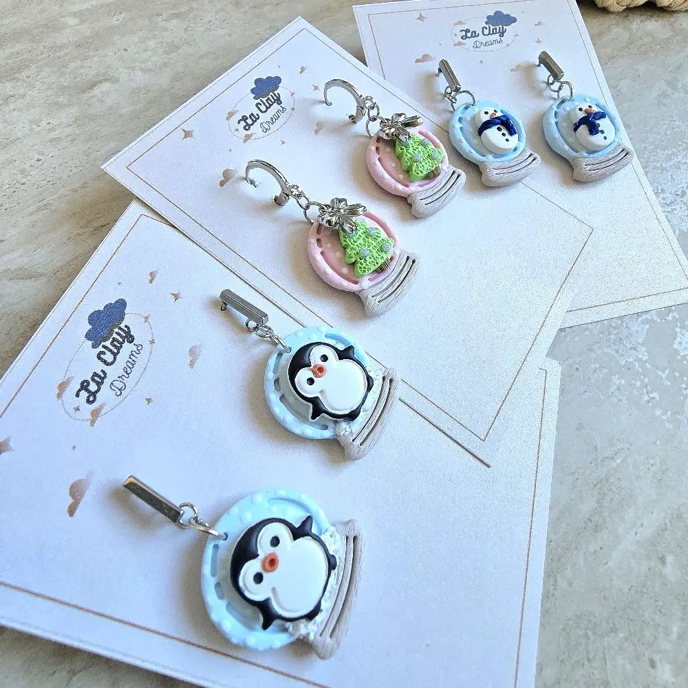 Creative Polymerclay Earrings Featuring cute variations of snowglobe Christmas designs,  a christmas tree,  a pinguin and a snowman