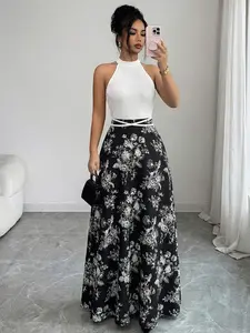 A classic long dress with black-and-white patchwork and floral prints, featuring a halter neck, waist cinching and a full flared skirt. Suitable for weddings, dinners, parties, dates and daily outings.