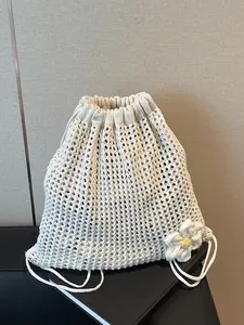 Forest style knitted drawstring bag with hollowed out mesh design, three-dimensional flower shaped embellishment, drawstring drawstring buckle shape, gentle beige tone, large storage capacity, fresh and healing feeling