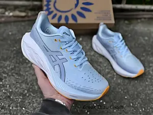 Soft sky blue mesh running trainers with clean white curved cushion midsoles & orange toe accents