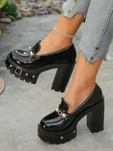 A pair of Women's Platform Block Heel Loafers, Patent Leather Upper, Chunky Studded Lug Sole, Pearl Buckle Accent, Edgy Platform Shoes, High Heel Loafers for Parties, Night Out, Street Style, Bold Footwear, Slip-On Design, Trendy Heeled Loafers