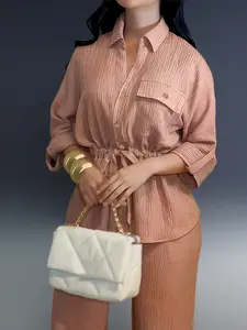 Elegant two-piece set for women: textured fabric, vintage collar, rolled sleeves and front flap pockets with buttons.Top with drawstring waist design, loose pants with elastic waistband.The perfect outfit for commuting