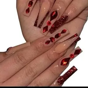 Red Glitter Nails with Red Rhinestones and Clear Tips for a Sparkling Look