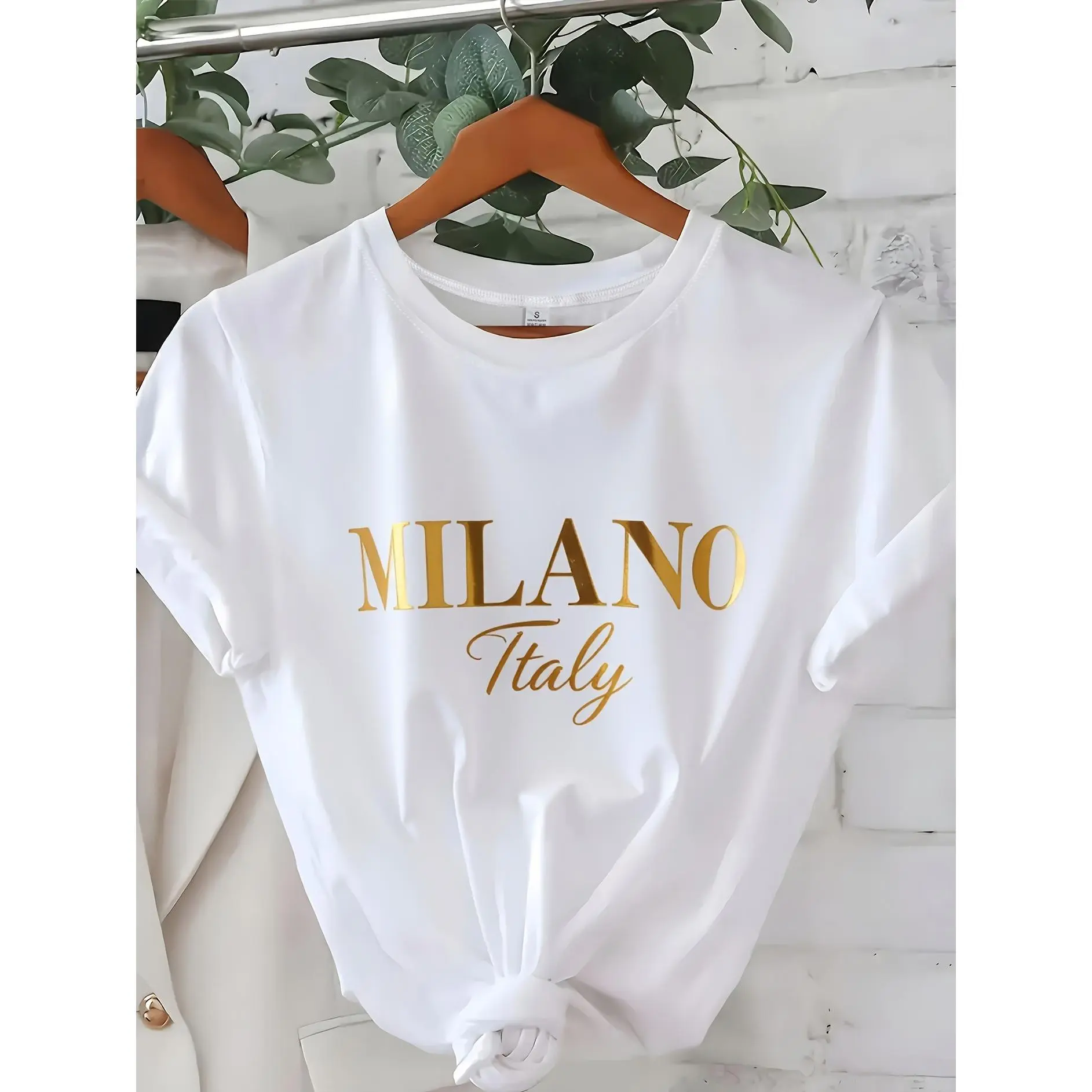 C571 Exuding elegance and modern luxury the design features MILANO in bold shimmering Golden uppercase letters with ITALY elegantly scripted in a smaller lighter font directly beneath all set against a deep black background The minimalist sty