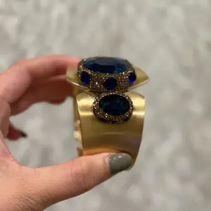 Bracelet’s Gold-Tone Cuff with Blue Gemstone Accents for Elegant Styling